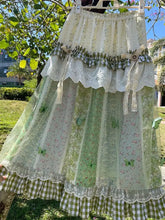 Women's green floral ruffle long skirt with A-line silhouette.